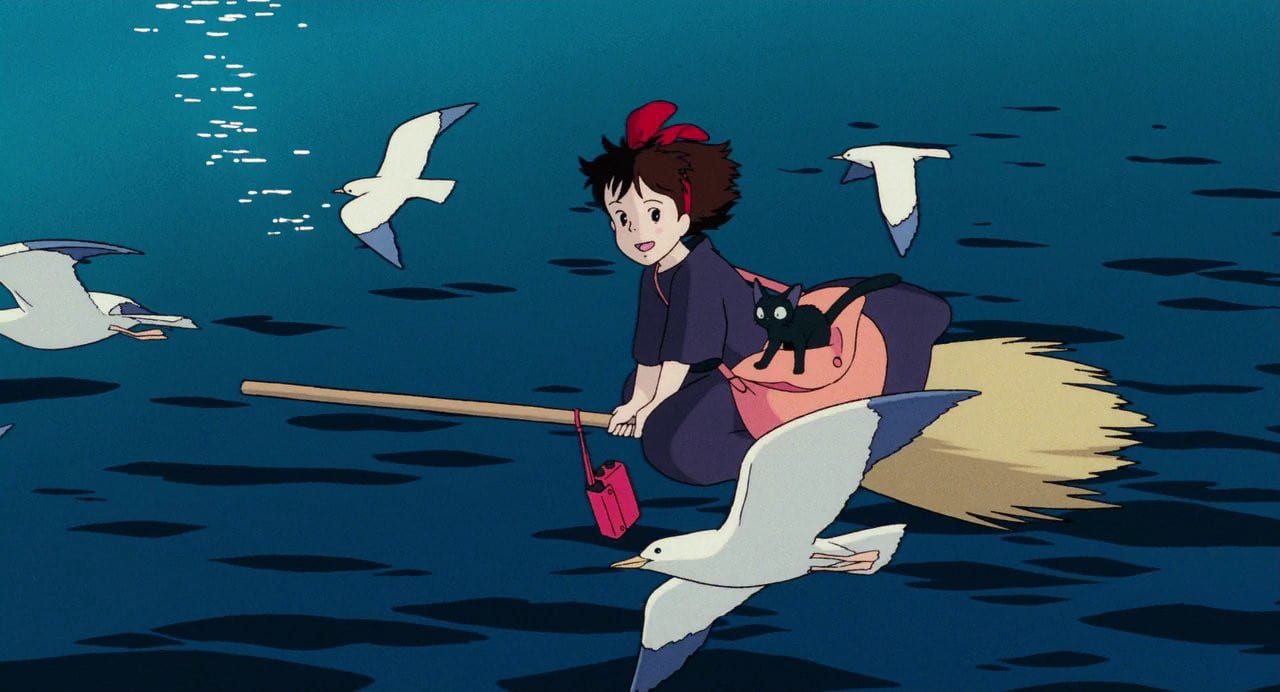 Animated character Kiki flying on a broomstick