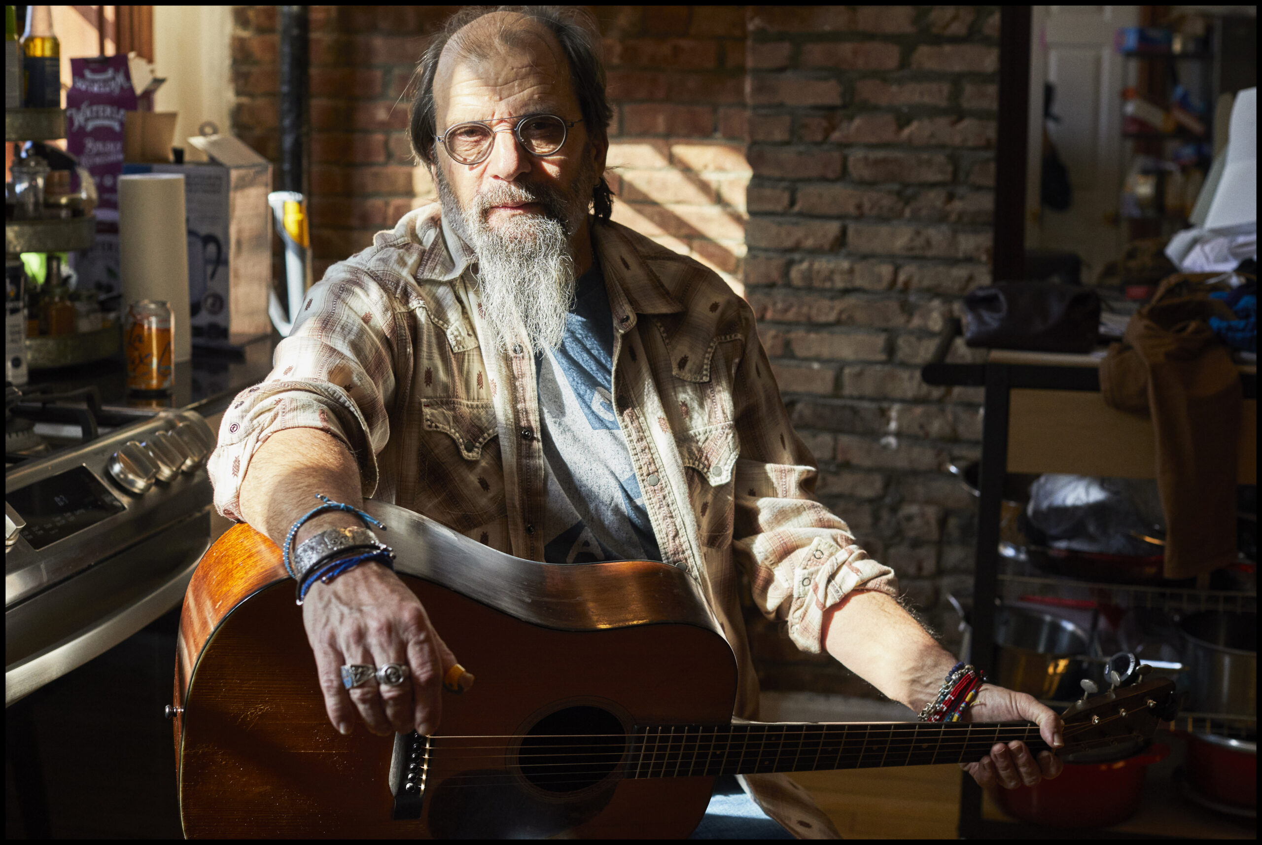 Steve Earle sits with his guitar