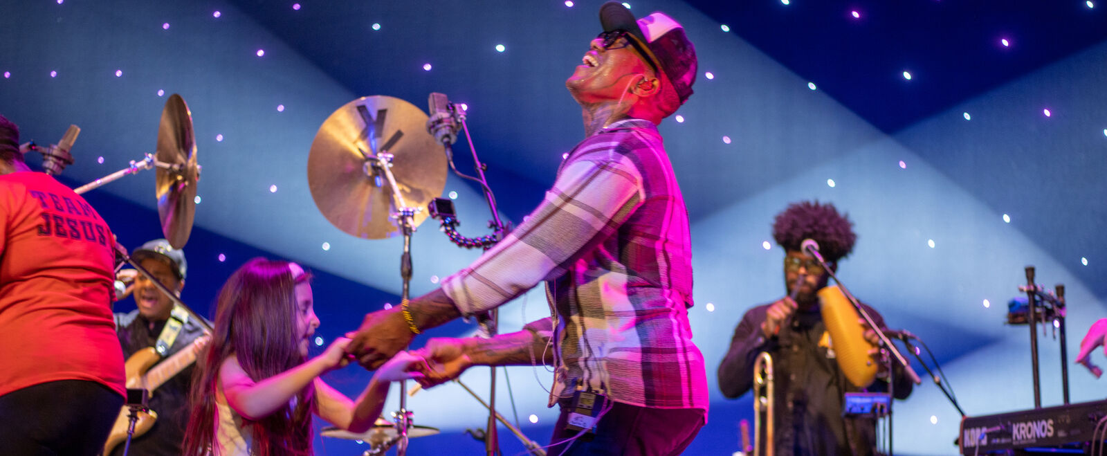 Performers and audience members engage on stage together