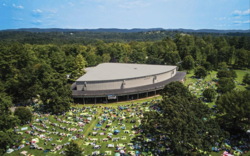 A covered stage in a field, from birdseye view