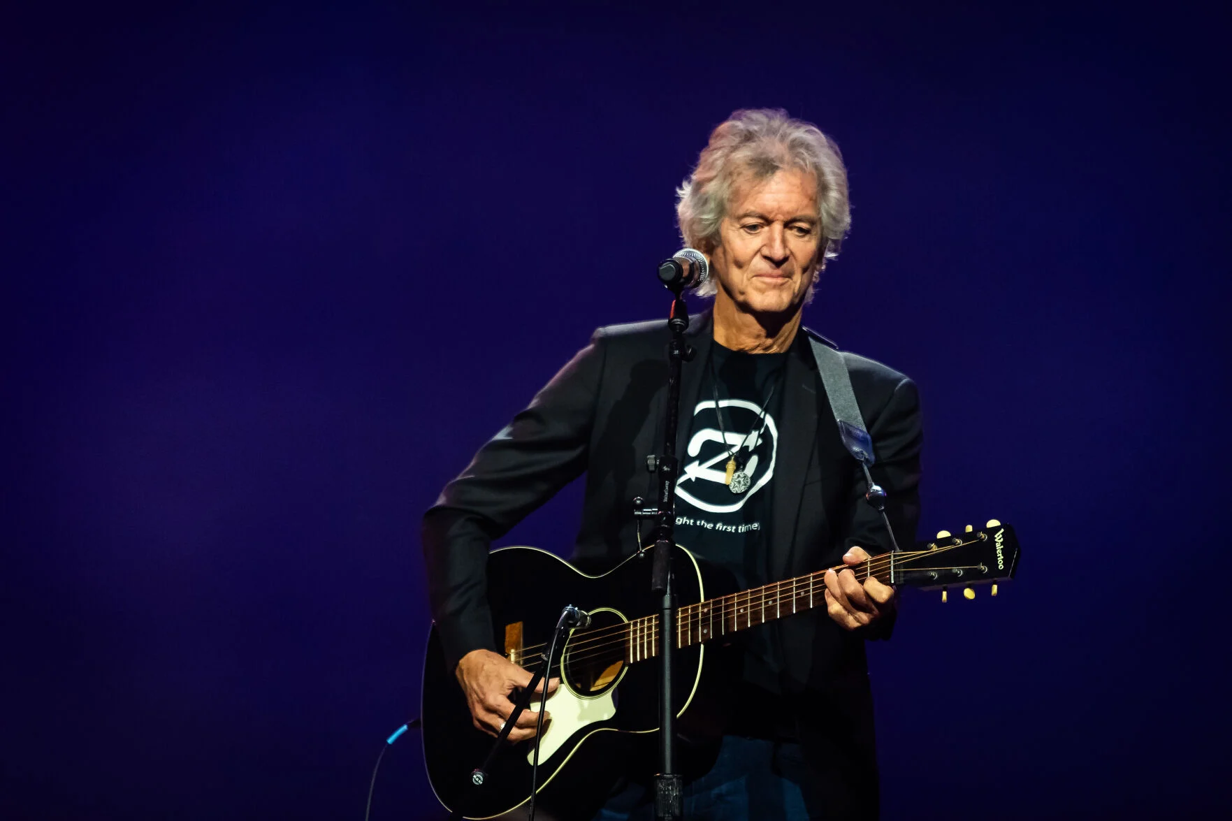 Musician Rodney Crowell - a man on stage with a guitar