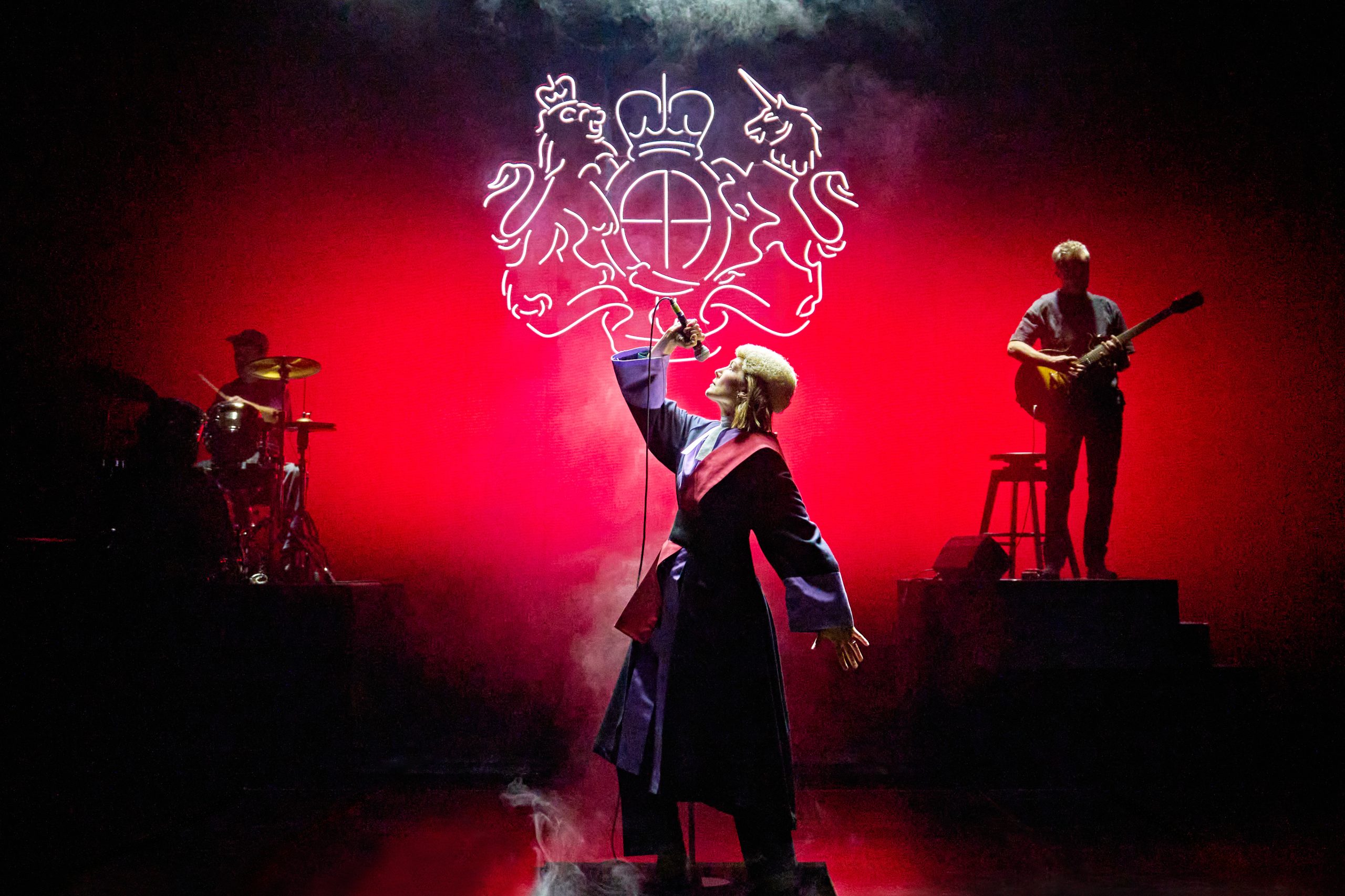 A person on stage holds up a microphone