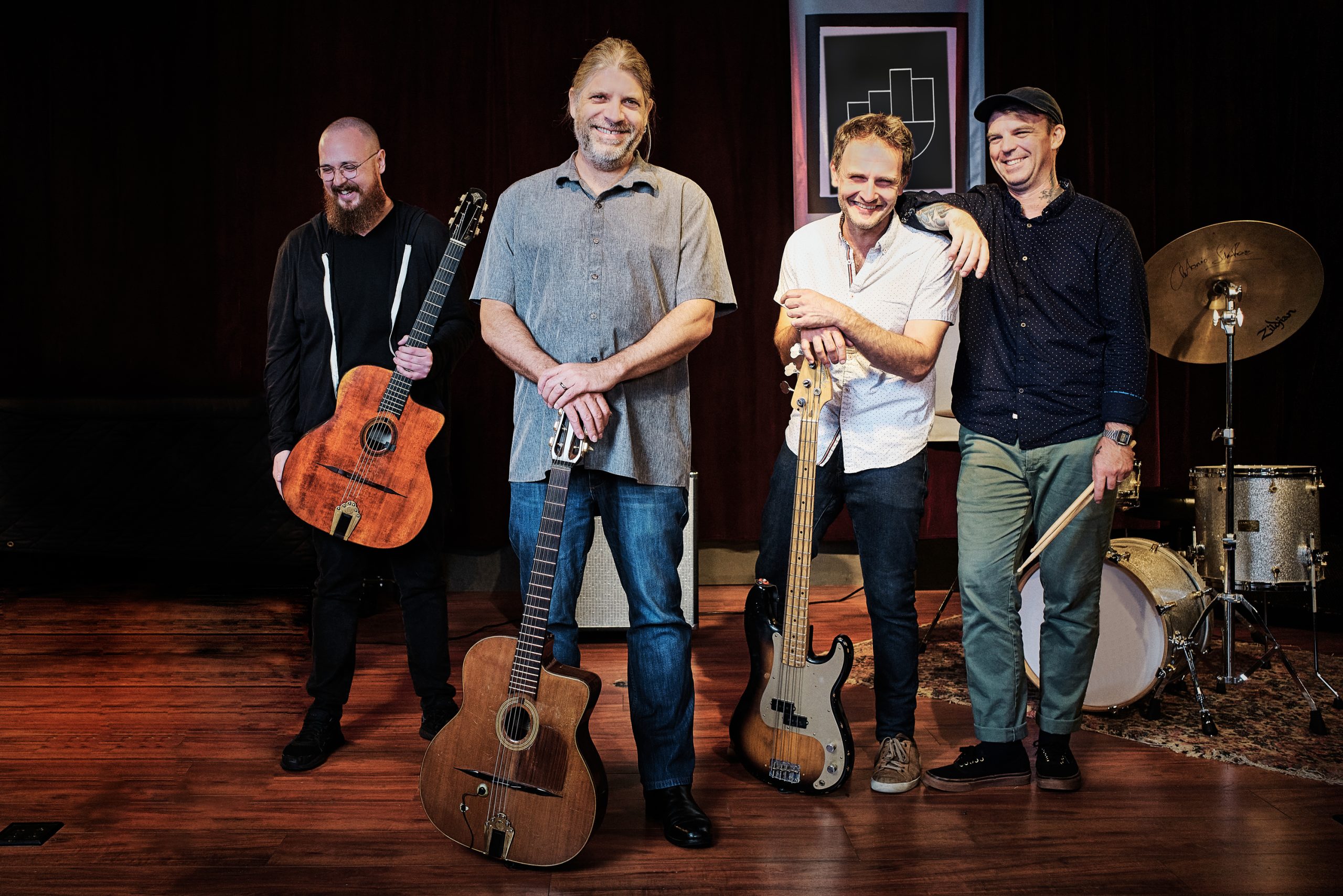 Four members of a jazz quartet posing with instruments