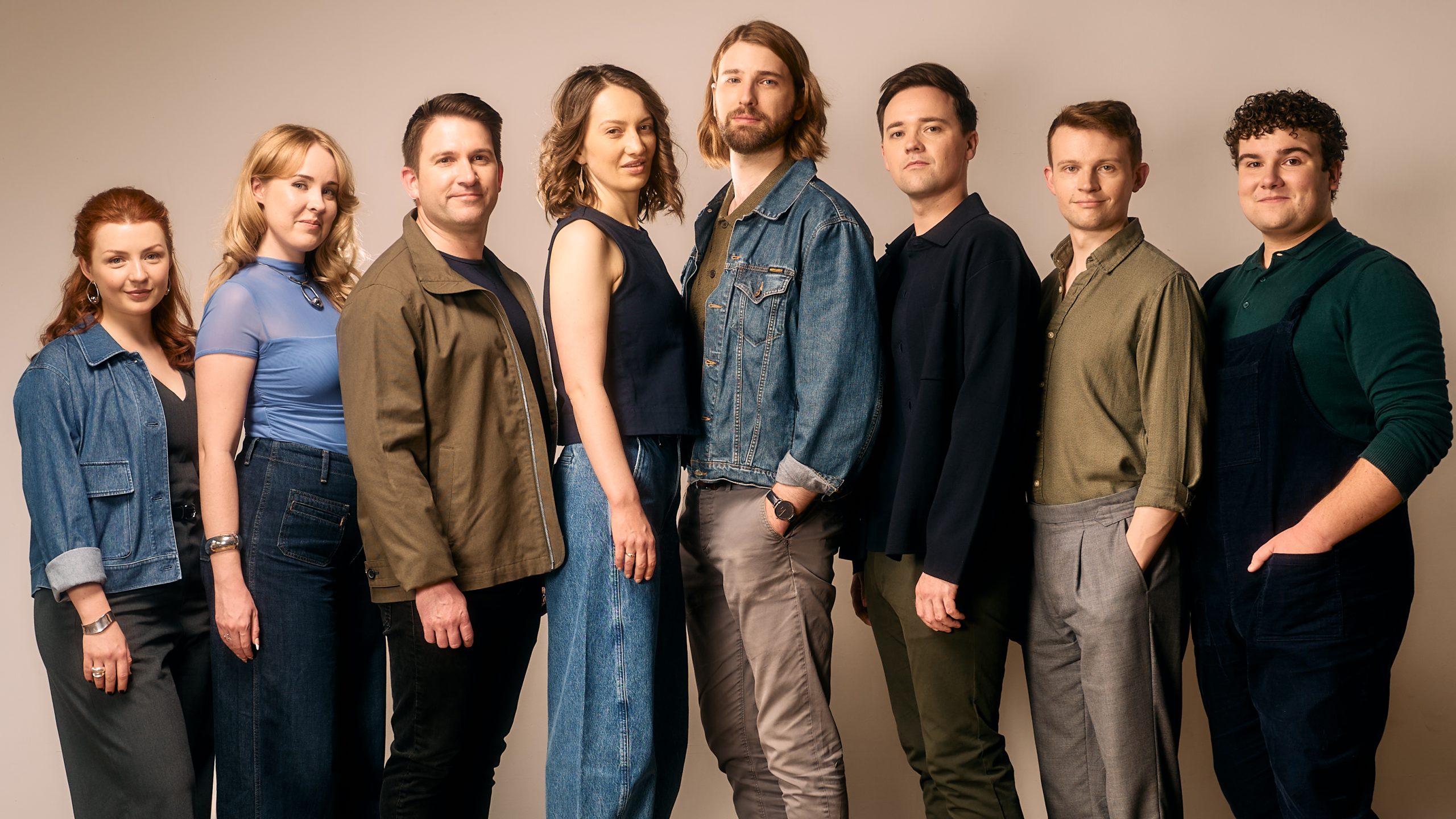 Eight people standing in a row