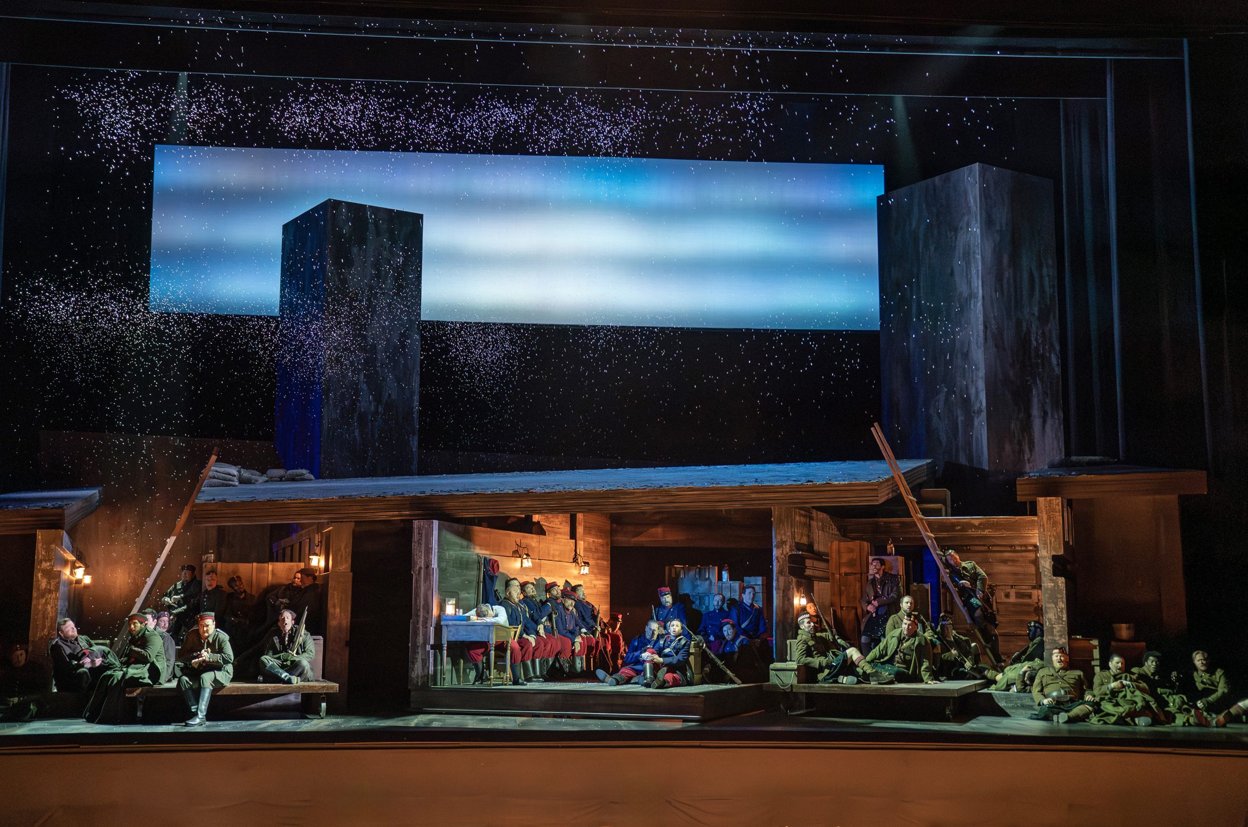 An opera staging of a snowy scene with soldiers